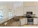 Modern kitchen with stainless steel appliances and granite countertops at 267 Lecturn St, Port Charlotte, FL 33954