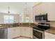 Modern kitchen with stainless steel appliances and granite countertops at 267 Lecturn St, Port Charlotte, FL 33954