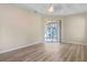 Bright living room featuring wood-look floors and sliding glass doors leading to a patio at 267 Lecturn St, Port Charlotte, FL 33954