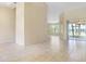 Open living room with tile floors and view into kitchen area at 267 Lecturn St, Port Charlotte, FL 33954