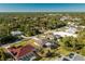 Aerial view showcasing a neighborhood with single-Gathering homes and lush greenery at 2696 Mather Ln, North Port, FL 34286