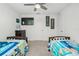 Bedroom with two twin beds, ceiling fan and dresser at 2696 Mather Ln, North Port, FL 34286