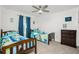 Bedroom with two twin beds, ceiling fan and dresser at 2696 Mather Ln, North Port, FL 34286