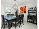 Bright dining room featuring a large table, six chairs, and a wine bar at 2696 Mather Ln, North Port, FL 34286