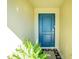 Front entrance with blue door and potted plant at 2696 Mather Ln, North Port, FL 34286