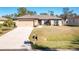 Single-story home with attached garage and driveway at 2696 Mather Ln, North Port, FL 34286