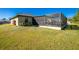 Exterior view showcasing the home's backyard and screened enclosure at 2696 Mather Ln, North Port, FL 34286