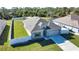 Single-story home with a gray roof, fenced yard, and two-car garage at 3393 Kacher Rd, North Port, FL 34288