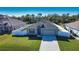 One-story house with gray roof and attached garage, large fenced backyard at 3393 Kacher Rd, North Port, FL 34288