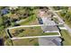 Aerial view showcasing a house with a large backyard and surrounding neighborhood at 3393 Kacher Rd, North Port, FL 34288