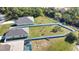 Aerial view showing two houses, large fenced yards, and a pool at 3393 Kacher Rd, North Port, FL 34288