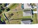 Aerial view of a home with a fenced backyard and a neighboring property with a pool at 3393 Kacher Rd, North Port, FL 34288
