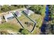 Elevated view of homes with fenced yards, lush greenery, and a creek at 3393 Kacher Rd, North Port, FL 34288