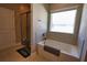 Bathroom featuring a shower over tub, tiled walls and flooring, and a window for natural light at 3393 Kacher Rd, North Port, FL 34288