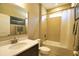 Bathroom featuring tiled walls, shower over tub and single vanity sink at 3393 Kacher Rd, North Port, FL 34288