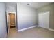 Empty bedroom with tiled flooring, closet doors, and neutral walls at 3393 Kacher Rd, North Port, FL 34288