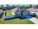 Well-maintained home with a two-car garage, gray siding, white fence, and manicured lawn and landscaping at 3393 Kacher Rd, North Port, FL 34288