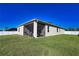 Exterior of the home shows a screened lanai and large fenced yard for outdoor living at 3393 Kacher Rd, North Port, FL 34288