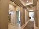 Inviting hallway with neutral-toned walls, recessed lighting, decorative ceiling trim, and entryways to rooms at 3393 Kacher Rd, North Port, FL 34288
