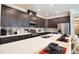 Modern kitchen with dark cabinets, quartz countertops, and island seating at 3393 Kacher Rd, North Port, FL 34288