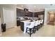 Modern kitchen with dark cabinets, quartz countertops, and stainless steel appliances at 3393 Kacher Rd, North Port, FL 34288