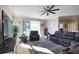 Bright living area with a ceiling fan, sliding glass doors, a comfortable seating arrangement, and tile flooring at 3393 Kacher Rd, North Port, FL 34288
