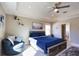 Cozy main bedroom with tray ceilings, a fan, two windows, carpeted floors, and an ensuite bathroom at 3393 Kacher Rd, North Port, FL 34288