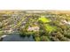 Aerial view of house and surrounding area, showcasing a large lot and lake at 3409 Carpel St, Plant City, FL 33566