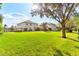 Large backyard with lush grass and mature trees at 3409 Carpel St, Plant City, FL 33566