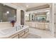 Elegant bathroom with soaking tub, double vanity, and separate shower at 3409 Carpel St, Plant City, FL 33566