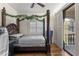 Spacious bedroom with a large four-poster bed and access to balcony at 3409 Carpel St, Plant City, FL 33566