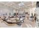 Spacious living room boasts a coffered ceiling, comfortable seating, and a grand fireplace at 3409 Carpel St, Plant City, FL 33566