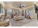 Luxurious main bedroom with ornate bed, seating area, and large TV at 3409 Carpel St, Plant City, FL 33566