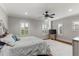 Bright main bedroom with plush bedding and hardwood floors at 3409 Carpel St, Plant City, FL 33566