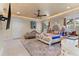 Spacious main bedroom with a large bed, seating area, and access to the bathroom at 3409 Carpel St, Plant City, FL 33566