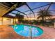 Relaxing kidney-shaped pool with a screened enclosure at 3819 Turtle Dove Blvd, Punta Gorda, FL 33950