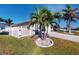 House exterior with palm trees, fenced yard, and a paved driveway at 5247 Conner Ter, Port Charlotte, FL 33981