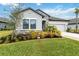 Front exterior view of a single-story house with landscaping, stone accents, and a welcoming appeal at 5640 Blue Reef Pl, Nokomis, FL 34275