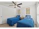 Bedroom with two twin beds, ceiling fan, and window at 10316 Charlotte Dr, Parrish, FL 34219