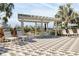 Poolside pergola with lounge chairs for relaxation at 10316 Charlotte Dr, Parrish, FL 34219