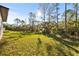 Large backyard with a grassy area and lush trees at 14059 Gailwood Ave, Port Charlotte, FL 33953