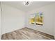 Bright bedroom with wood-look flooring and large window at 14059 Gailwood Ave, Port Charlotte, FL 33953