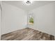 Bright bedroom with wood-look flooring and large window at 14059 Gailwood Ave, Port Charlotte, FL 33953