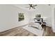 Spacious bedroom with ceiling fan, large window, and wood flooring at 14059 Gailwood Ave, Port Charlotte, FL 33953