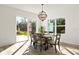 Bright dining room with sliding glass doors and a modern chandelier at 14059 Gailwood Ave, Port Charlotte, FL 33953