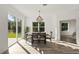 Bright dining room with sliding glass doors and a modern chandelier at 14059 Gailwood Ave, Port Charlotte, FL 33953