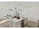 Kitchen island with white cabinets, quartz countertops, and stainless steel dishwasher at 14059 Gailwood Ave, Port Charlotte, FL 33953