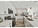 Modern kitchen with white cabinets, stainless steel appliances, and quartz countertops at 14059 Gailwood Ave, Port Charlotte, FL 33953