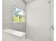 Clean and bright shower with a gray tile surround and a window at 14059 Gailwood Ave, Port Charlotte, FL 33953