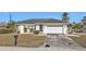 Single story home with attached garage and well-maintained lawn at 154 Hibiscus Dr, Punta Gorda, FL 33950